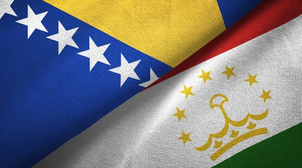 Bosnia y Herzegovina y Tayikistán dos banderas tela textil, textura de la tela — Foto de Stock