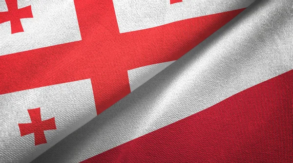 Geórgia e Polônia duas bandeiras de pano têxtil, textura de tecido — Fotografia de Stock