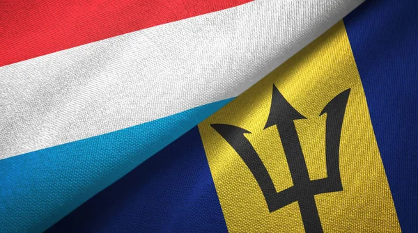 Lussemburgo e Barbados due bandiere tessuto, tessitura tessuto — Foto Stock