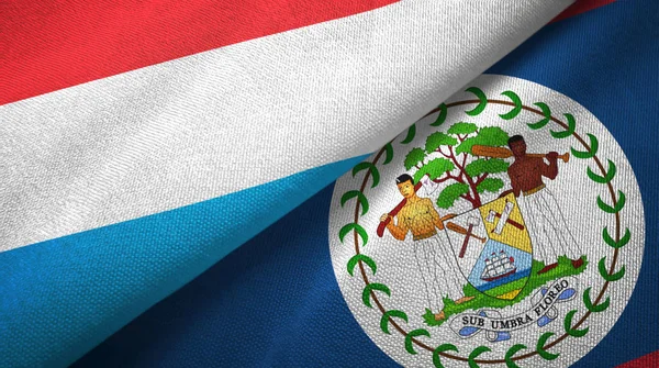 Lussemburgo e Belize due bandiere tessuto, tessitura tessuto — Foto Stock