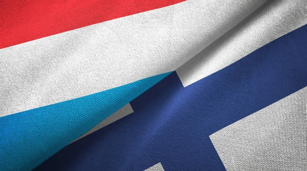 Lussemburgo e Finlandia due bandiere tessuto, tessitura tessuto — Foto Stock
