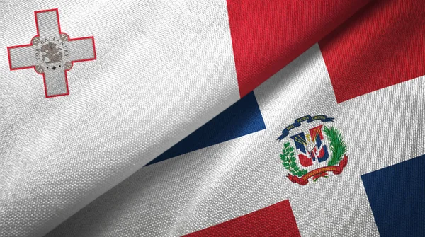 Málta és a Dominikai Köztársaság két zászló textil ruhával, szövet textúra — Stock Fotó