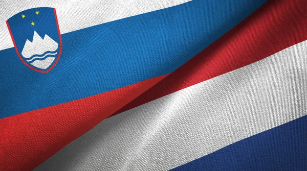 Slovinsko a Nizozemsko dvě vlajky textilní tkaniny, textura textilií — Stock fotografie