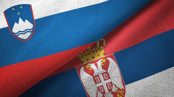 Словенія та Сербія два прапори текстильна тканина, текстура тканини — стокове фото