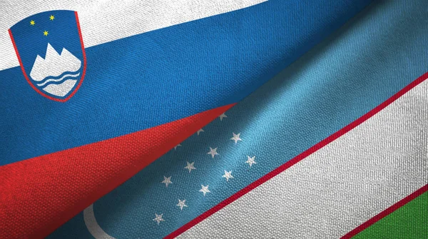 Eslovénia e Uzbequistão duas bandeiras de pano têxtil, textura de tecido — Fotografia de Stock