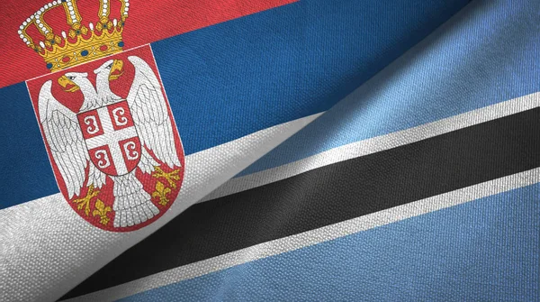 Serbien och Botswana två flaggor textil tyg, tyg konsistens — Stockfoto