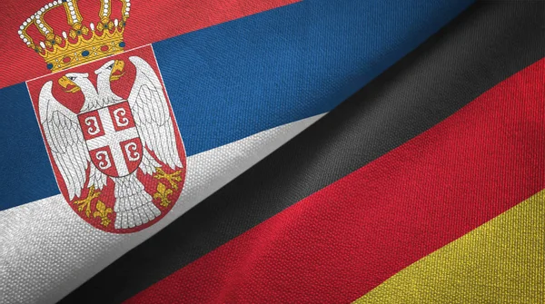 Сербія і Німеччина два прапори текстильна тканина, текстура тканини — стокове фото
