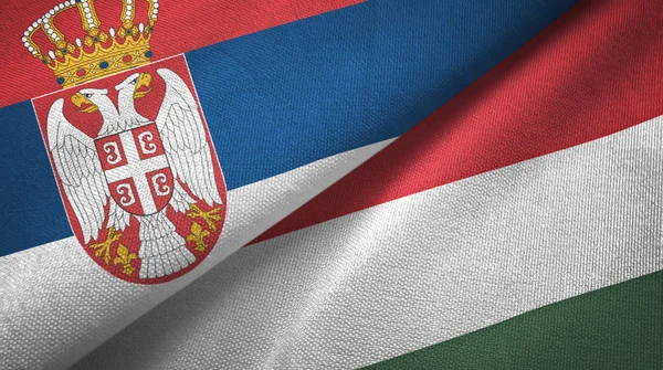 Serbien och Ungern två flaggor textil tyg, tyg konsistens — Stockfoto