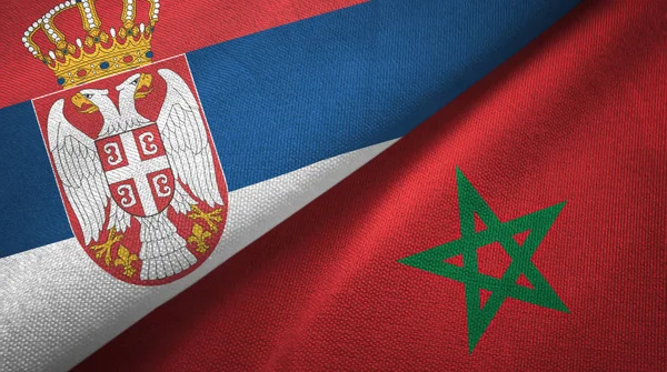 Servië en Marokko twee vlaggen textiel doek, weefsel textuur — Stockfoto