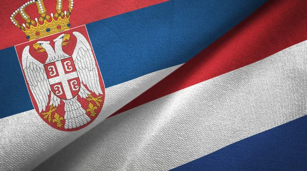 Serbia and Netherlands two flags textile cloth, fabric texture — Stock Photo, Image