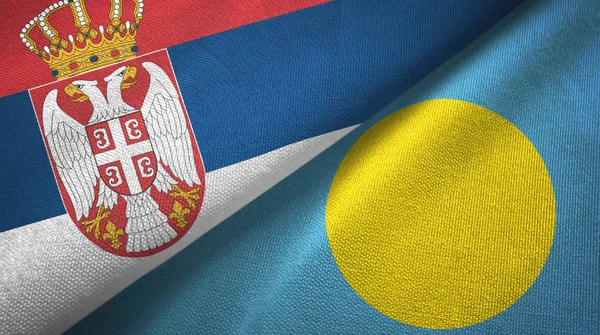 Srbsko a Palau, dvě vlajky textilní tkaniny, textura — Stock fotografie