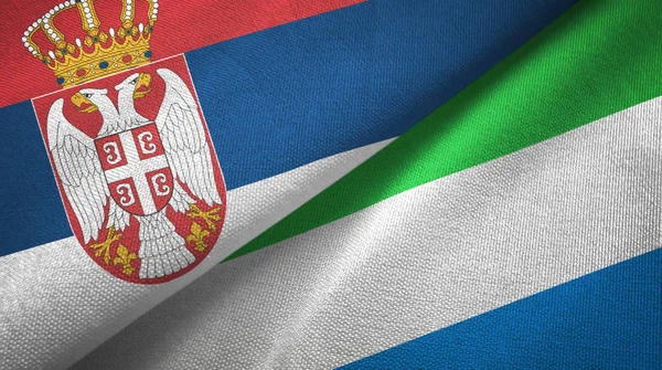 Serbien och Sierra Leone två flaggor textil tyg, tyg konsistens — Stockfoto