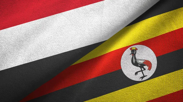 Jemen en Oeganda twee vlaggen textiel doek, stof textuur — Stockfoto