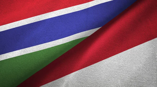 Gambia and Indonesia two flags textile cloth, fabric texture
