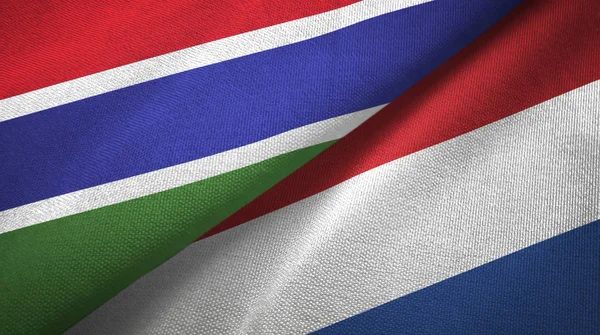 Гамбія і Нідерланди два прапори текстильна тканина, текстура тканини — стокове фото