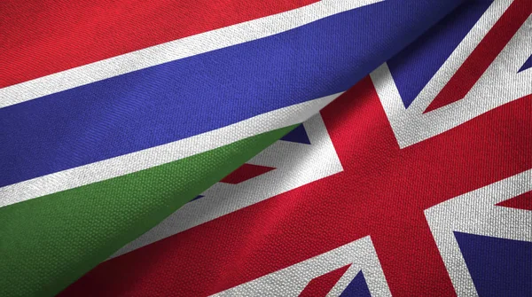 Gâmbia e Reino Unido duas bandeiras de pano têxtil, textura de tecido — Fotografia de Stock