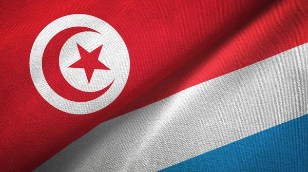 Туніс і Люксембург два прапори текстильна тканина, текстура тканини — стокове фото