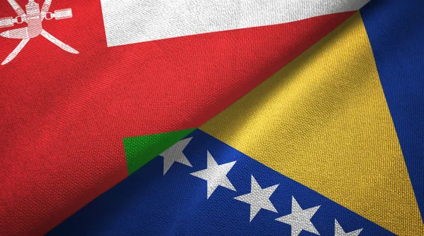 Omán y Bosnia y Herzegovina dos banderas tela textil, textura de la tela — Foto de Stock