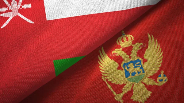 Omã e Montenegro duas bandeiras de pano têxtil, textura de tecido — Fotografia de Stock