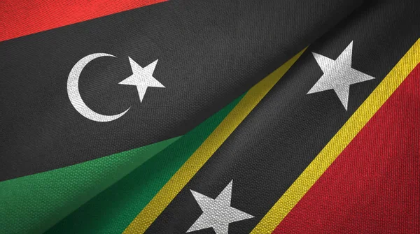 Líbia e São Cristóvão e Nevis duas bandeiras pano têxtil, textura de tecido — Fotografia de Stock