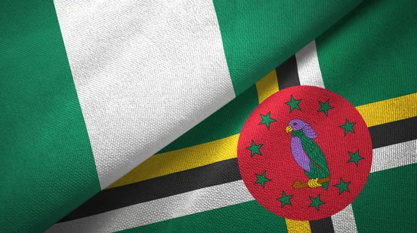 Nigeria e Dominica due bandiere tessuto, tessitura tessuto — Foto Stock