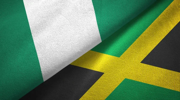 Nigéria és Jamaica két zászló textil ruhával, szövet textúra — Stock Fotó