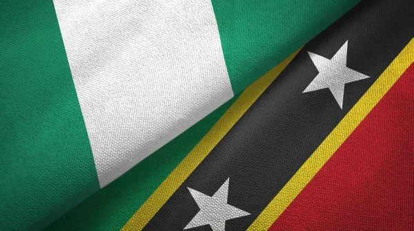 Nigéria e São Cristóvão e Nevis duas bandeiras de pano têxtil, textura de tecido — Fotografia de Stock