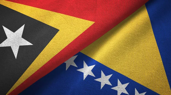 Timor Oriental y Bosnia y Herzegovina dos banderas tela textil, textura de la tela — Foto de Stock