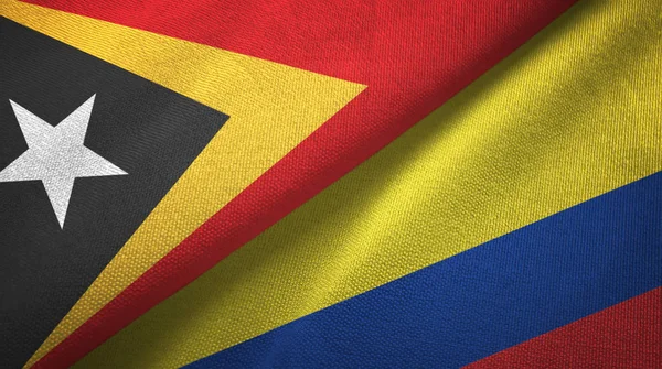 Timor Oriental y Colombia dos banderas tela textil, textura de la tela —  Fotos de Stock