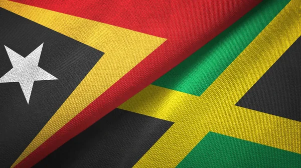 Восточный Тимор и Ямайка два флага текстильная ткань, текстура ткани — стоковое фото