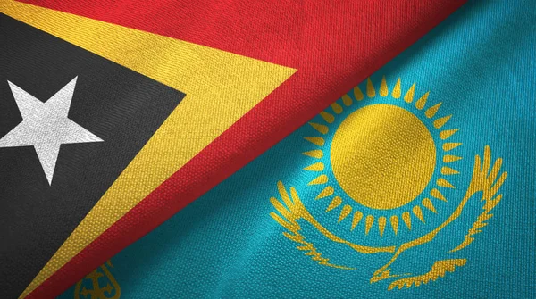 Timor Oriental y Kazajstán dos banderas tela textil, textura de la tela — Foto de Stock