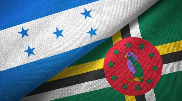 Honduras en Dominica twee vlaggen textiel doek, weefsel textuur — Stockfoto