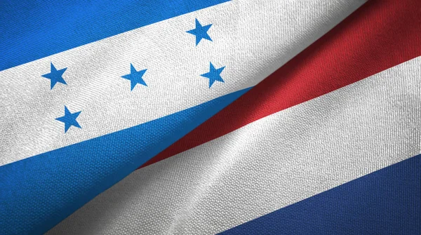 Honduras en Nederland twee vlaggen textiel doek, stof textuur — Stockfoto