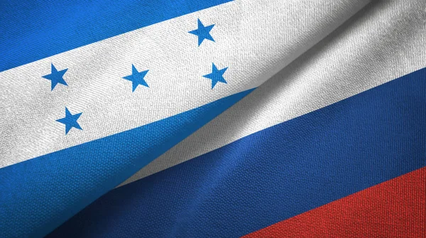 Honduras en Rusland twee vlaggen textiel doek, weefsel textuur — Stockfoto