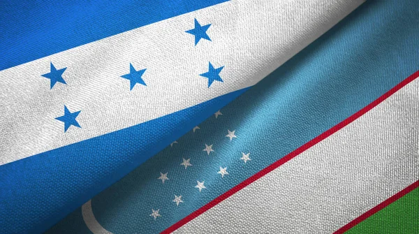 Honduras e Uzbequistão duas bandeiras de pano têxtil, textura de tecido — Fotografia de Stock