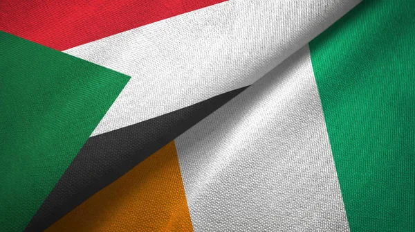 Szudán és Cote divoire Elefántcsontpart két zászló Textil szövet textúra — Stock Fotó