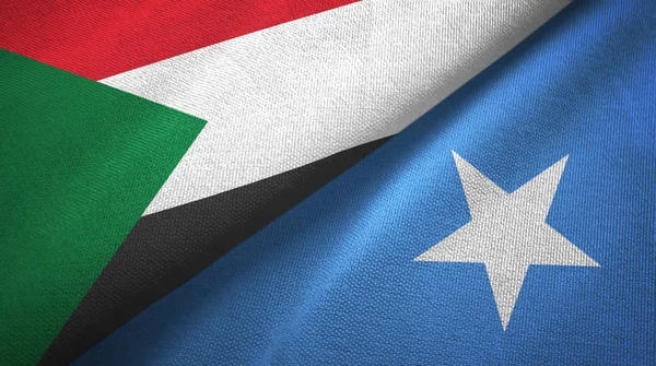 Sudán y Somalia dos banderas tela textil, textura de la tela — Foto de Stock