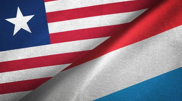 Liberia e Lussemburgo due bandiere tessuto, tessitura tessuto — Foto Stock