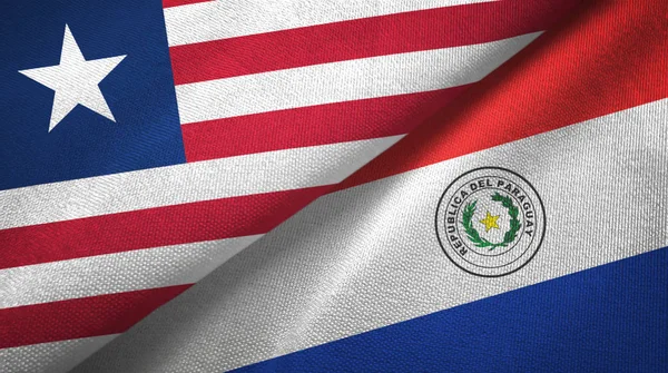 Libéria e Paraguai duas bandeiras de pano têxtil, textura de tecido — Fotografia de Stock