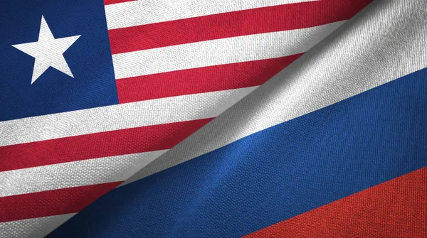 Liberia y Rusia dos banderas tela textil, textura de la tela — Foto de Stock