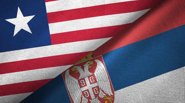 Либерия и Сербия два флага текстильная ткань, текстура ткани — стоковое фото