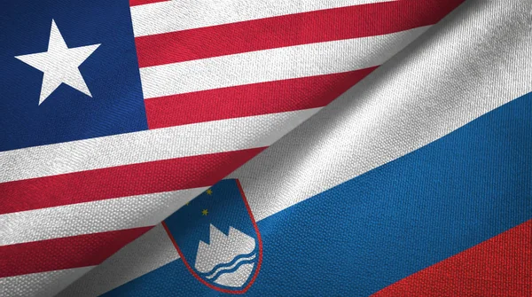 Liberia y Eslovenia dos banderas tela textil, textura de la tela — Foto de Stock