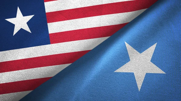 Liberia en Somalië twee vlaggen textiel doek, weefsel textuur — Stockfoto