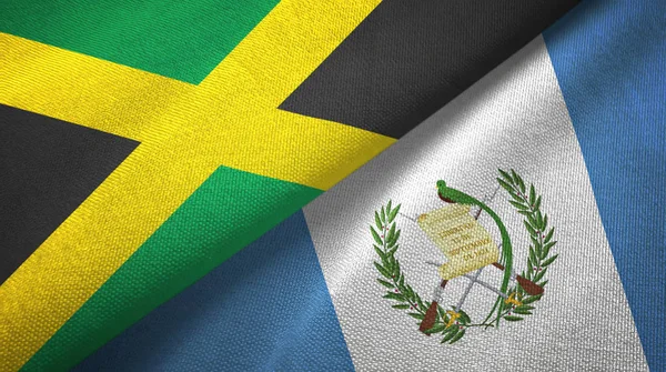 Jamaica e Guatemala duas bandeiras de pano têxtil, textura de tecido — Fotografia de Stock