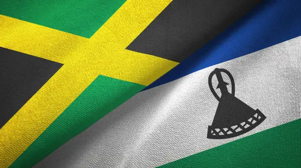Jamajka a Lesotho dvě vlajky textilní tkaniny, textura textilií — Stock fotografie