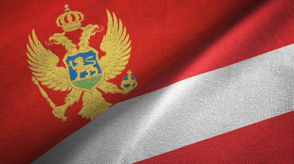 Montenegro och Österrike två flaggor textil trasa, tyg konsistens — Stockfoto