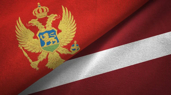 Montenegro e Letónia duas bandeiras de pano têxtil, textura de tecido — Fotografia de Stock