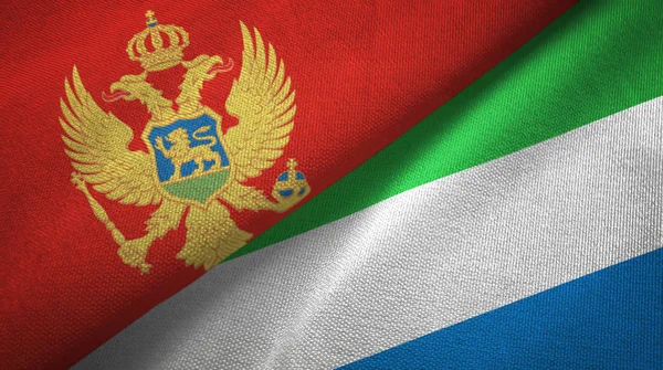 Montenegro e Serra Leoa duas bandeiras de pano têxtil, textura de tecido — Fotografia de Stock