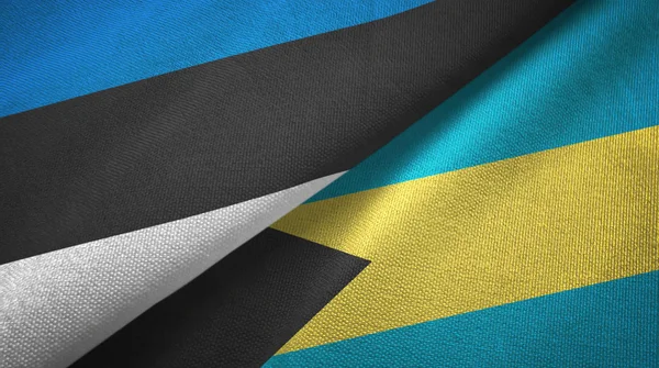 Észtország és Bahama-szigetek két zászló textil ruhával, szövet textúra — Stock Fotó