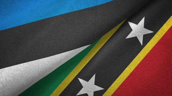 Estland en Saint Kitts en Nevis twee vlaggen textiel doek, stof textuur — Stockfoto